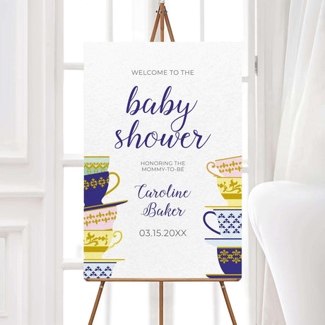 A Spot of Tea baby shower welcome sign featuring an elegant stack of colorful teacups with gold and blue patterns. The design includes delicate script typography with customizable text for the honoree’s name, event date, time, and venue. Perfect for a tea party-themed baby shower, afternoon tea, or high tea celebration. Professionally printed on premium cardstock with matching envelopes included.