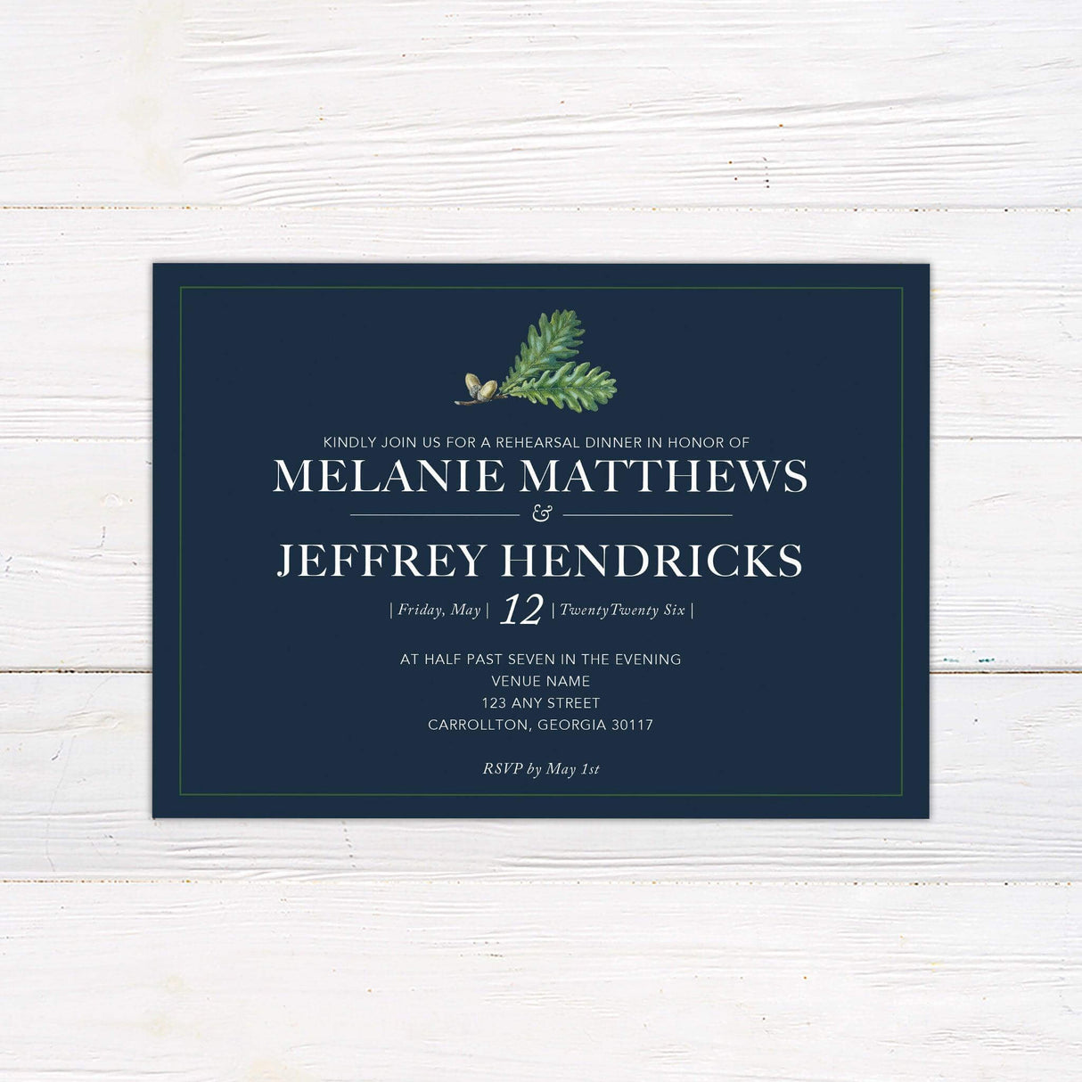 Generic wedding invitation with navy background, greenery detail, and elegant serif fonts, perfect for formal or nature-themed wedding ceremonies.