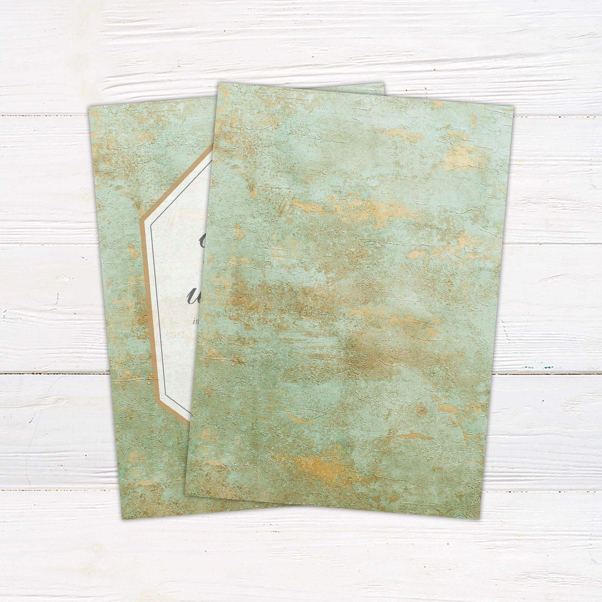 Wedding invitation with aged green copper texture background and gold geometric border. back