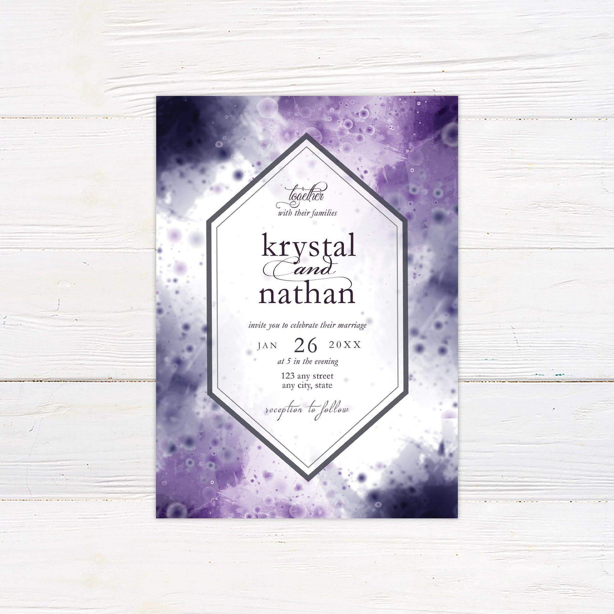 Wedding invitation with vibrant purple and blue watercolor splash background and white geometric frame.