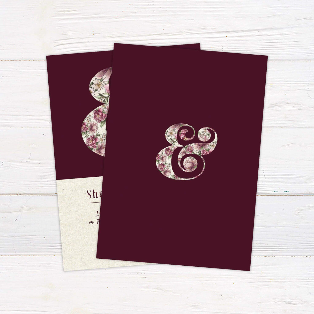 Wedding invitation with floral ampersand on burgundy background, cream base, and romantic script—perfect for garden or vintage-themed weddings. back