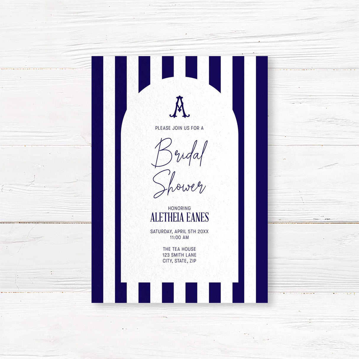 Bridal shower welcome sign with navy and white vertical stripes, antique serif monogram, elegant modern script and serif fonts, and a white arch panel to welcome guests in style.