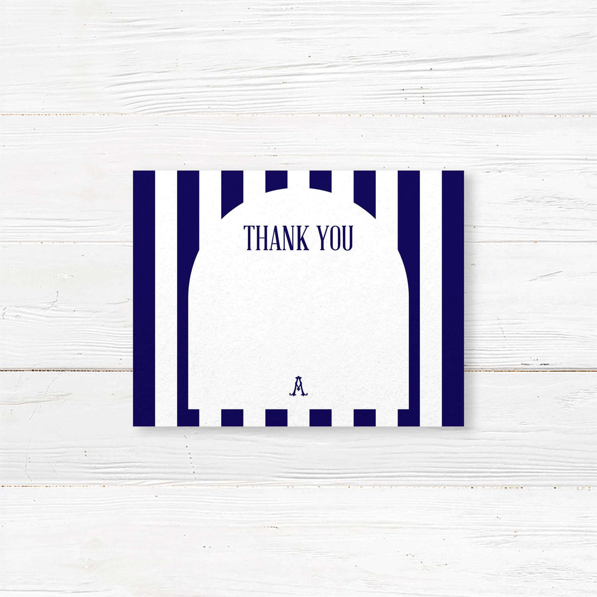 Thank you card featuring navy and white vertical stripes, serif monogram crest, clean modern script and serif typography, and a white arched center panel. Matches the Antique Bridal Shower suite.
