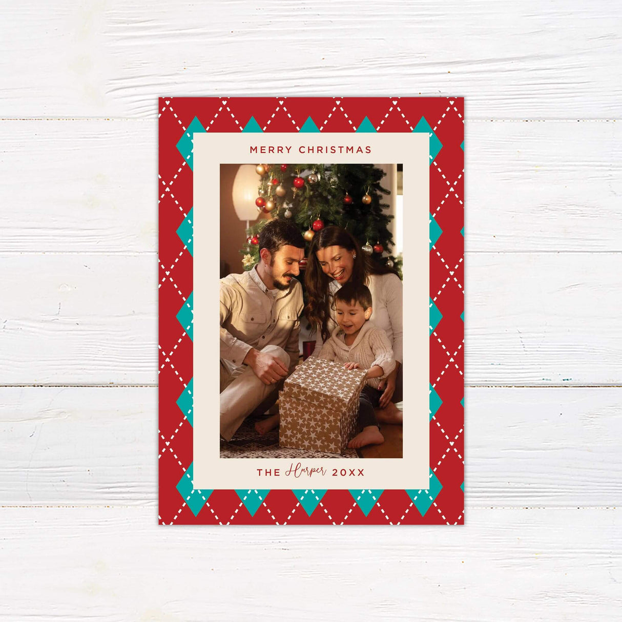 Personalized Christmas card with red and teal argyle border, family photo, and custom holiday greeting text.