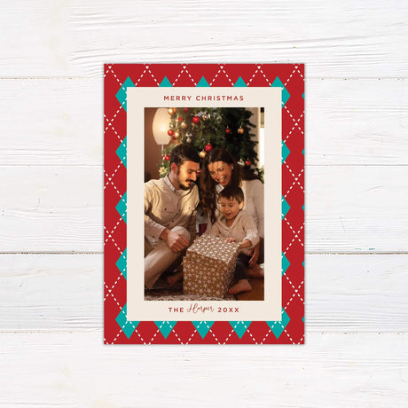 Personalized Christmas card with red and teal argyle border, family photo, and custom holiday greeting text.