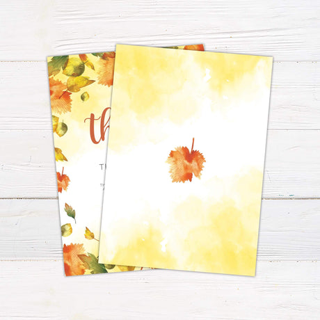 Autumn Leaves Give Thanks invitation card for Thanksgiving feast, featuring fall-themed design with colorful leaves on a wooden background.