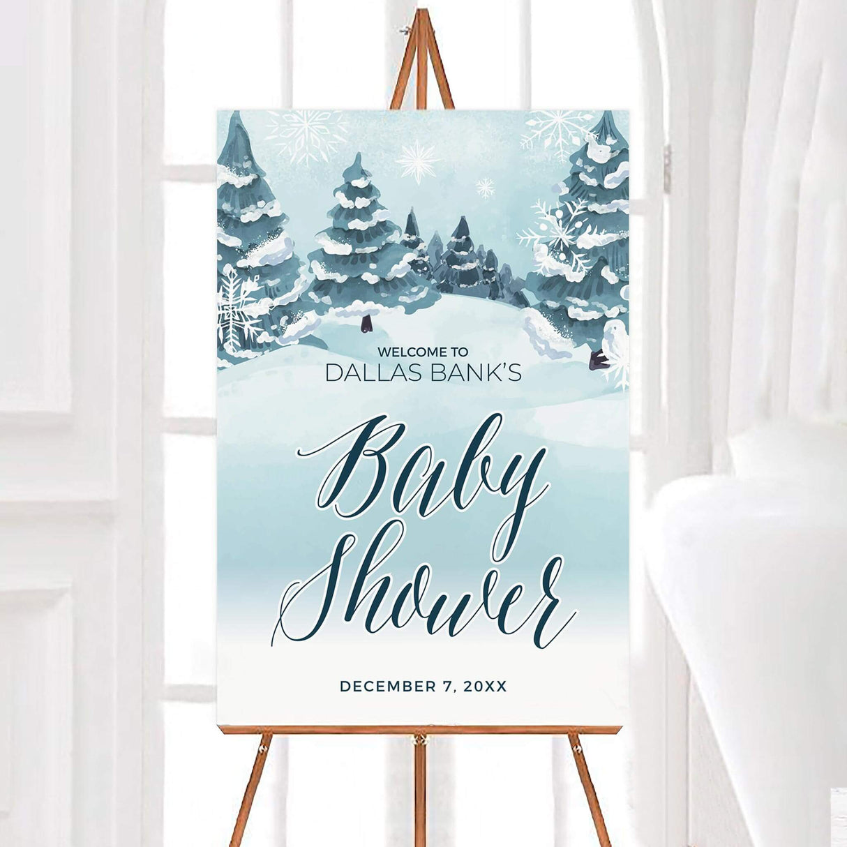 Winter-themed baby shower invitation with snowy trees and elegant script, featuring the text 'Baby Shower' for a December event.