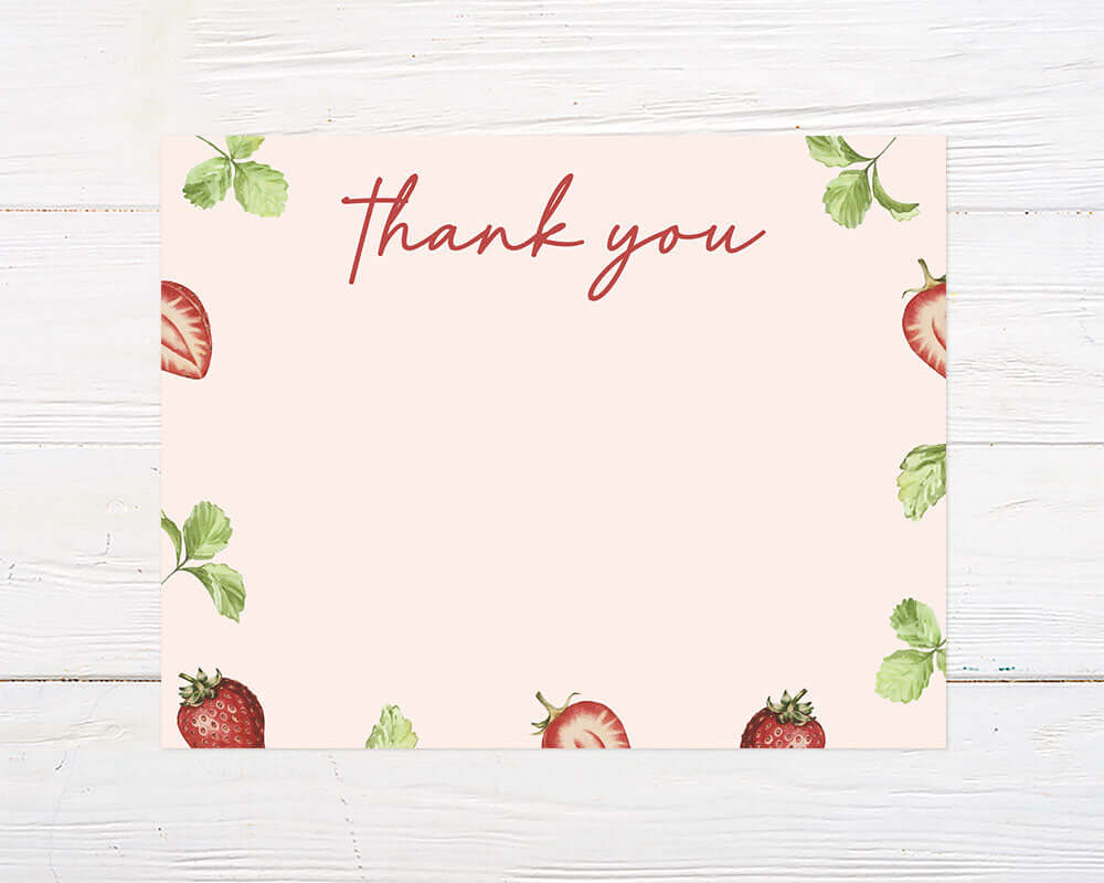 Watercolor thank you card with a soft pink background, featuring whole and sliced strawberries along with green strawberry leaves framing the edges. The center has ample blank space with "Thank you" written in a red handwritten-style font at the top.