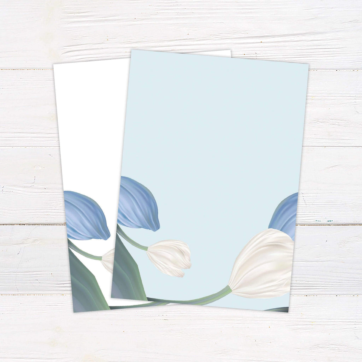 Minimalist floral wedding invitation with illustrated blue and white tulips and elegant serif text on a soft ivory background for fall or garden weddings. back