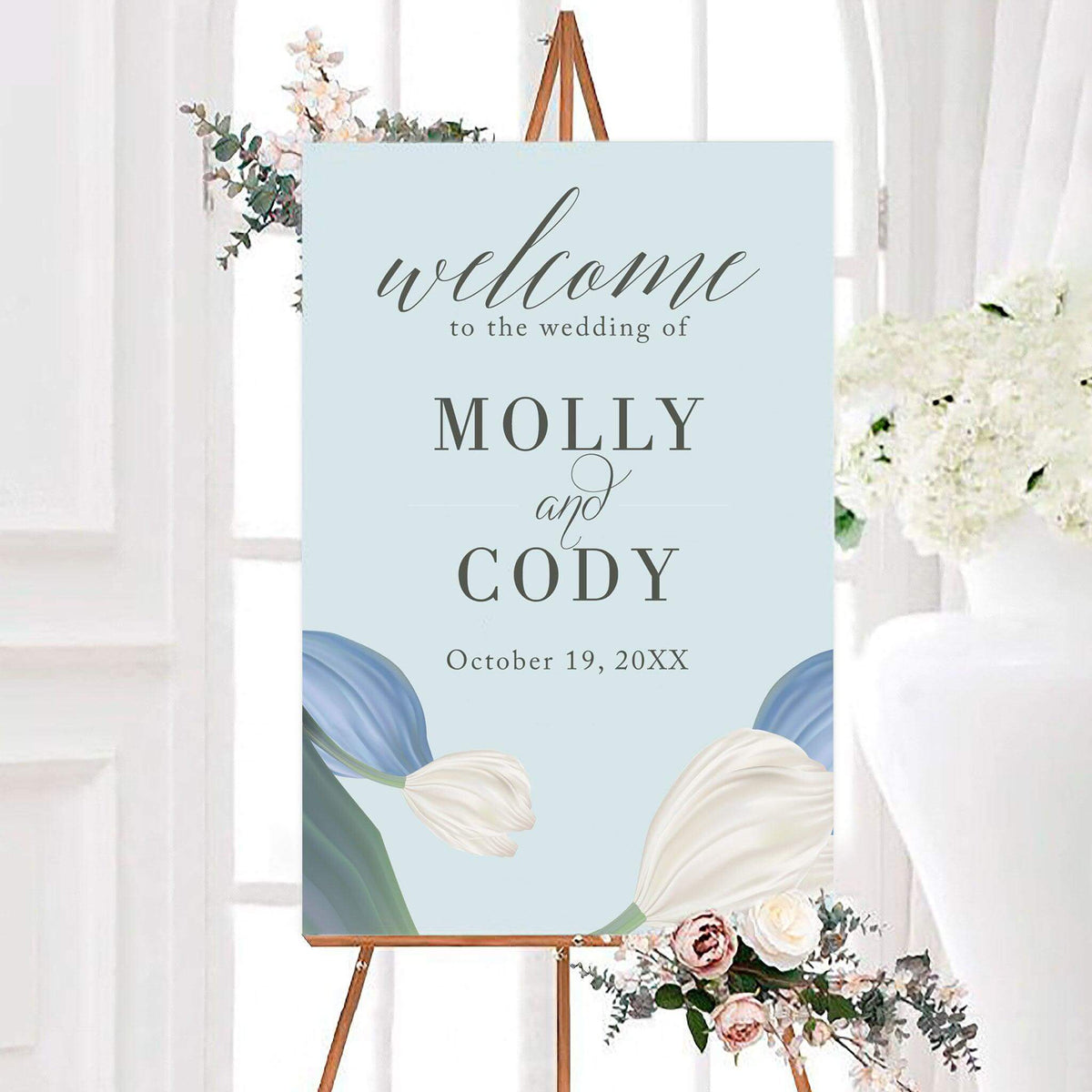 Elegant big floral wedding welcome sign featuring oversized sculpted flowers and leafy botanical accents. The sign is personalized with the couple's names and wedding date.