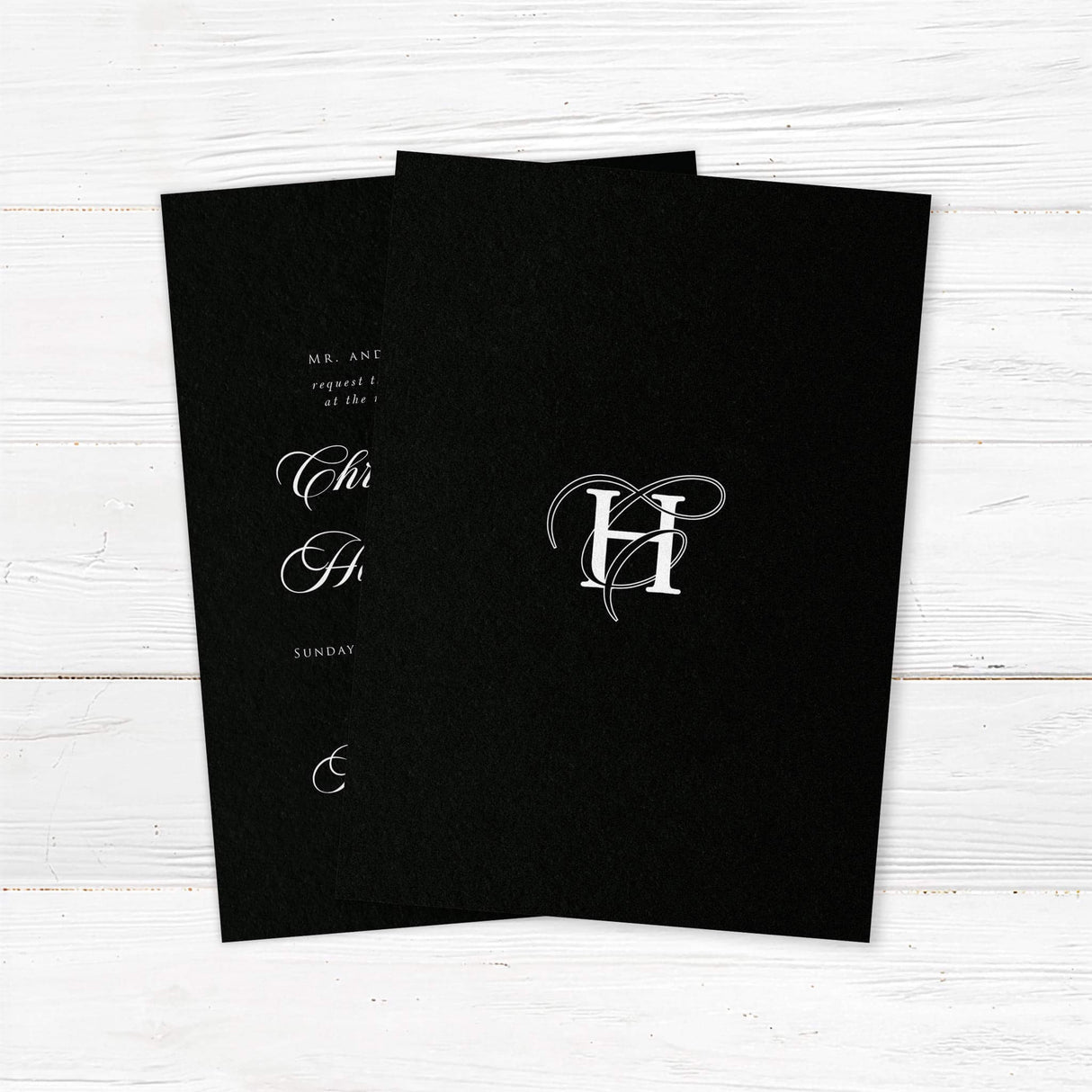 Black Entwined Initials Wedding Invitation - Elegant wedding invitation featuring a solid black background, ornate white monogram at the top, white serif and flourished calligraphy script fonts, and a formal centered layout for black-tie weddings. - back side