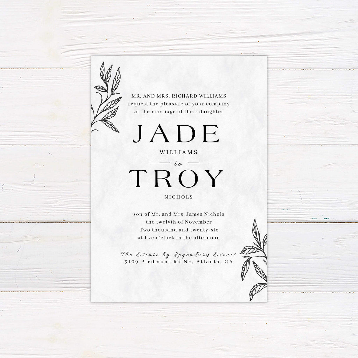 Modern botanical wedding invitation with marble background, outlined black leaves, and formal serif fonts—ideal for minimalist or fall weddings.