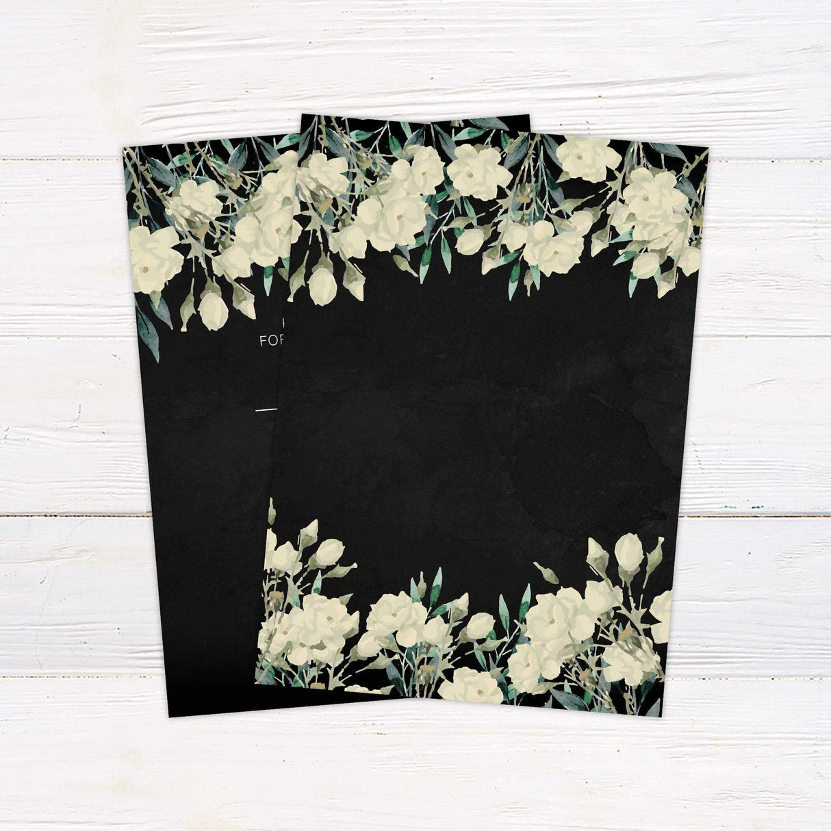 Black wedding invitation with white and cream roses, watercolor greenery, and elegant script and serif fonts—ideal for fall or evening weddings. back