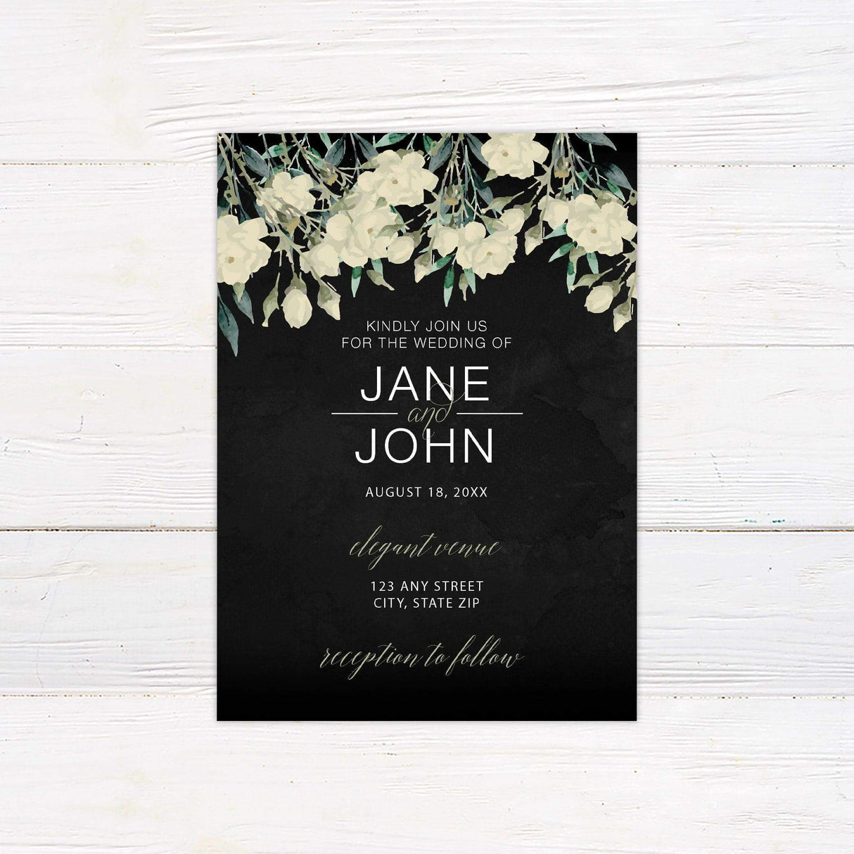 Black wedding invitation with white and cream roses, watercolor greenery, and elegant script and serif fonts—ideal for fall or evening weddings.