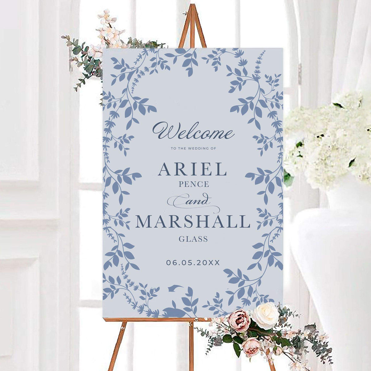 Elegant blue bell wedding welcome sign featuring a delicate botanical vine and floral border around personalized names. Classic typography and script lettering complete the romantic garden-inspired design.