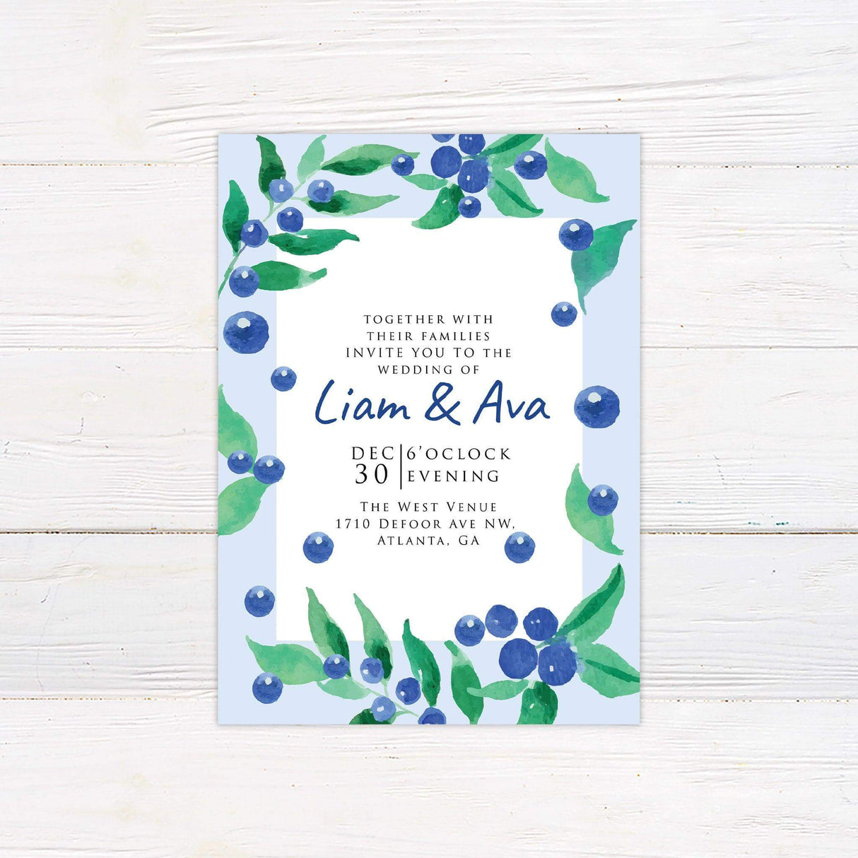 Blueberry-themed wedding invitation with watercolor berries and greenery on a soft blue background, featuring elegant serif and handwritten fonts.