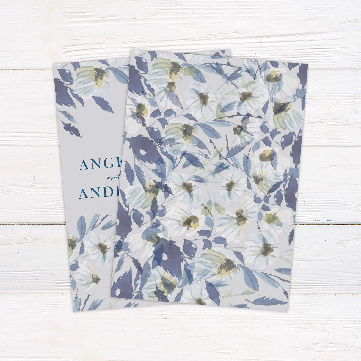 Watercolor wedding invitation with soft blue and lavender wildflowers, elegant serif and script fonts, and a neutral background for spring garden weddings. back