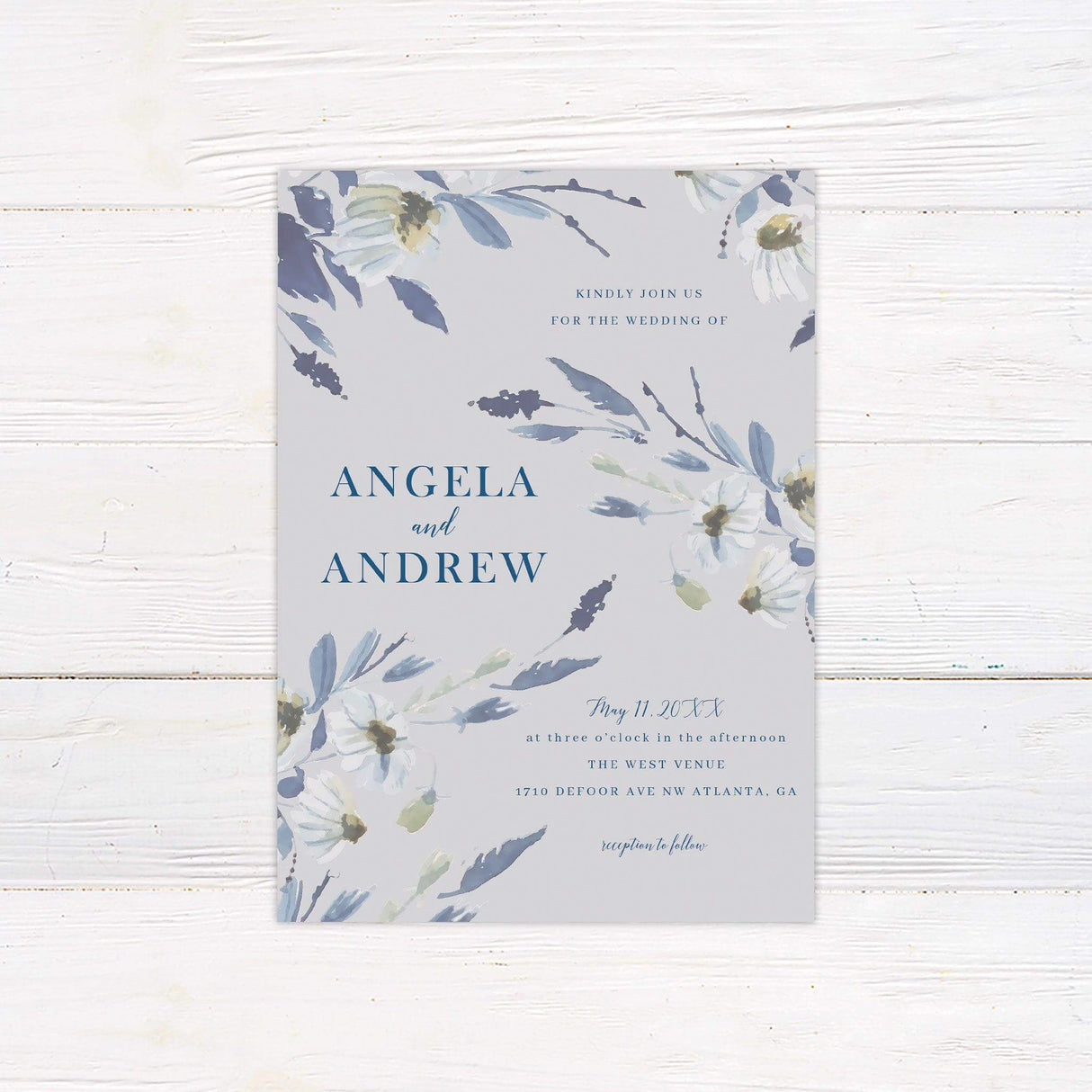 Watercolor wedding invitation with soft blue and lavender wildflowers, elegant serif and script fonts, and a neutral background for spring garden weddings.