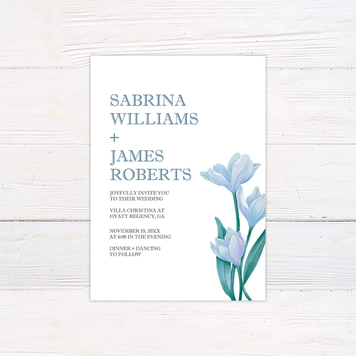 Minimalist wedding invitation with modern serif fonts, soft blue watercolor lilies, and clean layout for elegant evening or garden weddings.
