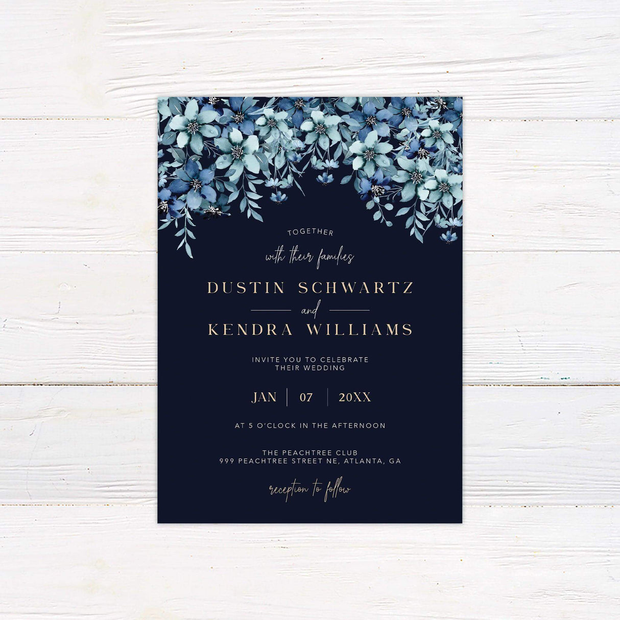 Elegant wedding invitation with navy background, cascading blue watercolor flowers, and gold serif typography—ideal for winter or evening weddings.