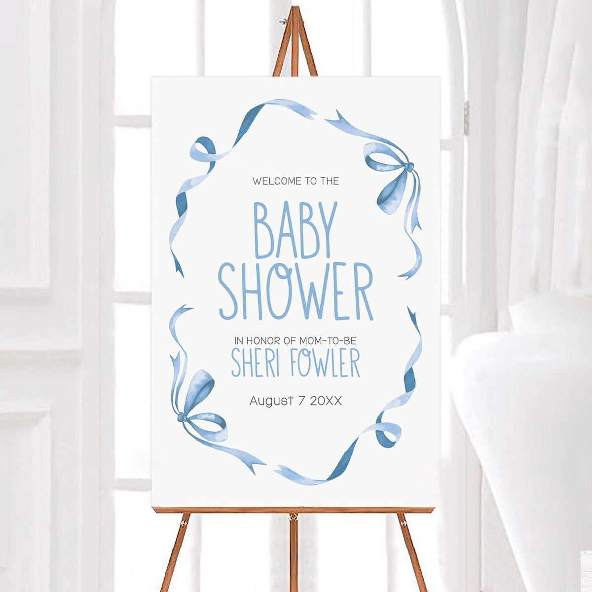 Personalized sweet ribbons and bows baby shower welcome sign featuring flowing blue watercolor ribbons and delicate bows framing elegant blue lettering on a white background. The ribbon themed design includes customizable names and an event date.