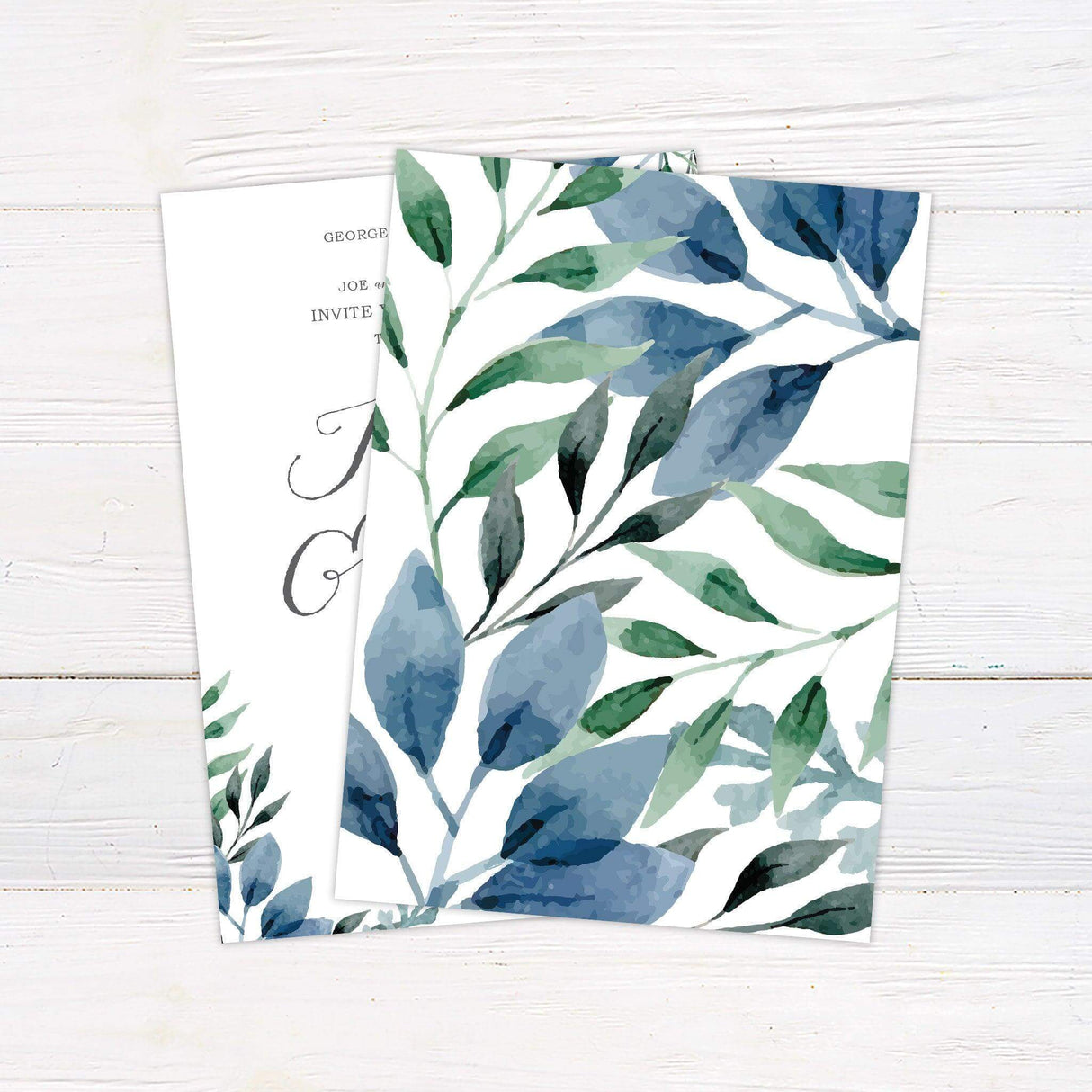 Elegant wedding invitation with watercolor blue and green leaves and modern calligraphy on a white background. Back.
