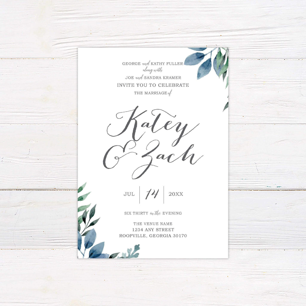 Elegant wedding invitation with watercolor blue and green leaves and modern calligraphy on a white background.