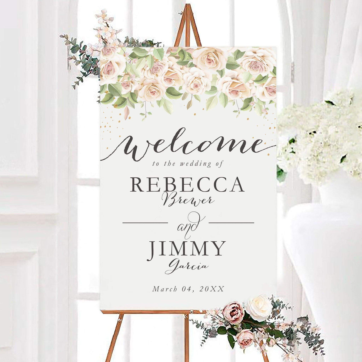 Blush pink roses wedding welcome sign featuring blush and ivory roses with soft green leaves across the top. Elegant personalized lettering displays the couple’s names and wedding date.