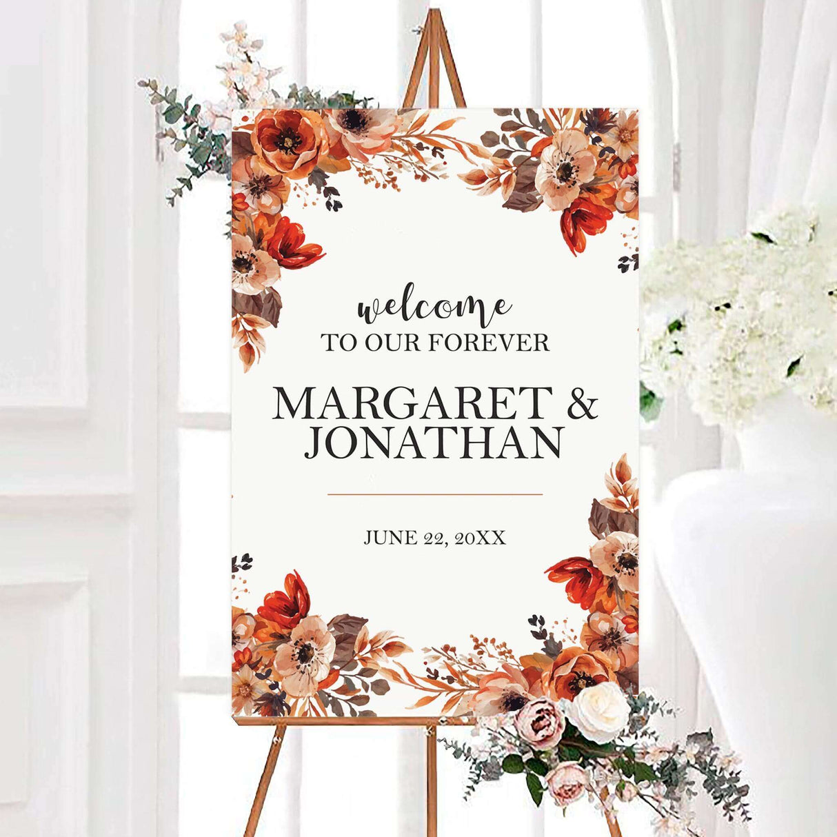 Boho floral wedding welcome sign framed with burnt orange, terracotta, peach, cream, and brown watercolor flowers. The design features the couple’s names and wedding date in elegant black typography.