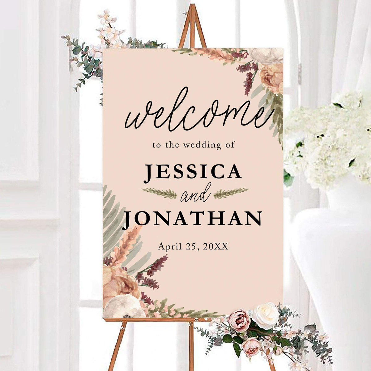Boho rose wedding welcome sign featuring soft watercolor flowers and greenery on a warm neutral background. Personalized lettering displays the couple’s names and wedding date.