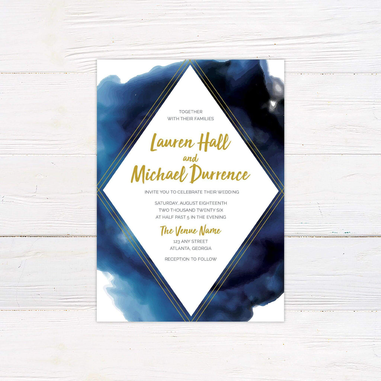 Bold blue watercolor wedding invitation with gold geometric framing, featuring modern calligraphy and elegant layout for an evening wedding.