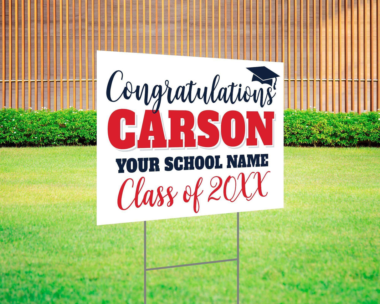 Custom graduation yard sign with bold name design in red and black, featuring a congratulatory message, a graduation cap graphic, and customizable school name and class year. Printed on durable Coreplast plastic, available in single or double-sided options. Perfect for high school and college graduates.