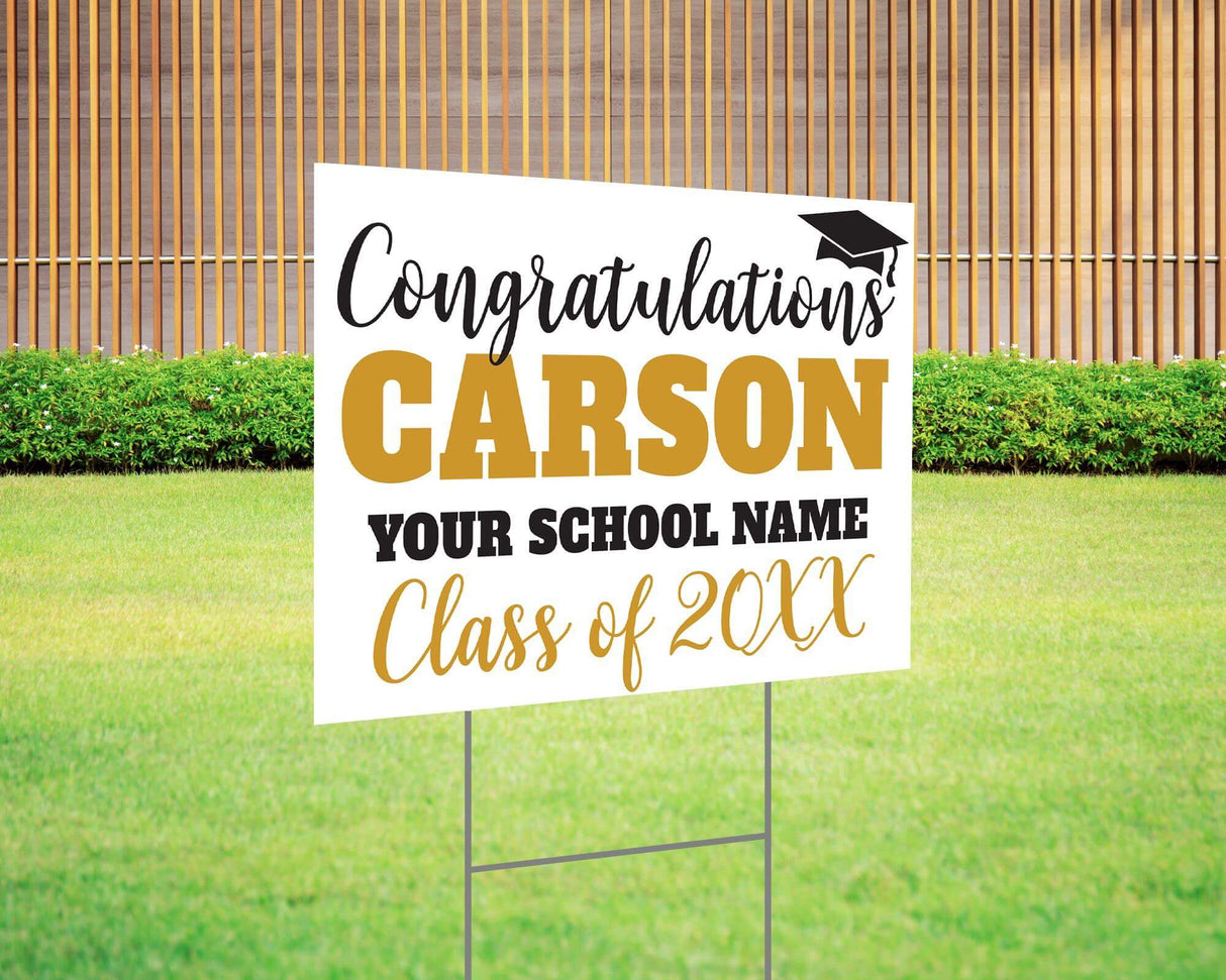 Custom graduation yard sign with bold name design in gold and black, featuring a congratulatory message, a graduation cap graphic, and customizable school name and class year. Printed on durable Coreplast plastic, available in single or double-sided options. Perfect for high school and college graduates.