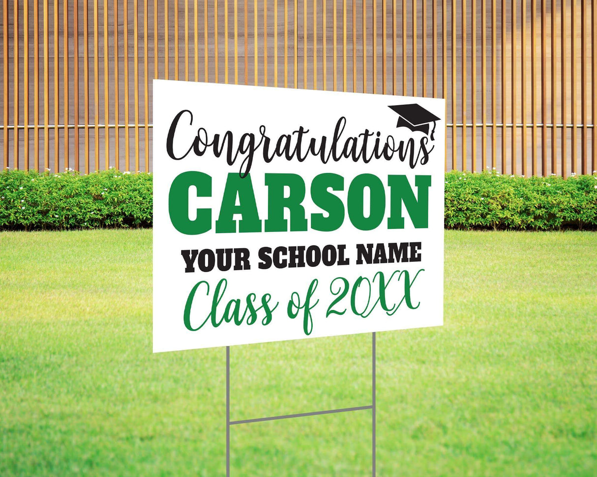 Custom graduation yard sign with bold name design in green and black, featuring a congratulatory message, a graduation cap graphic, and customizable school name and class year. Printed on durable Coreplast plastic, available in single or double-sided options. Perfect for high school and college graduates.
