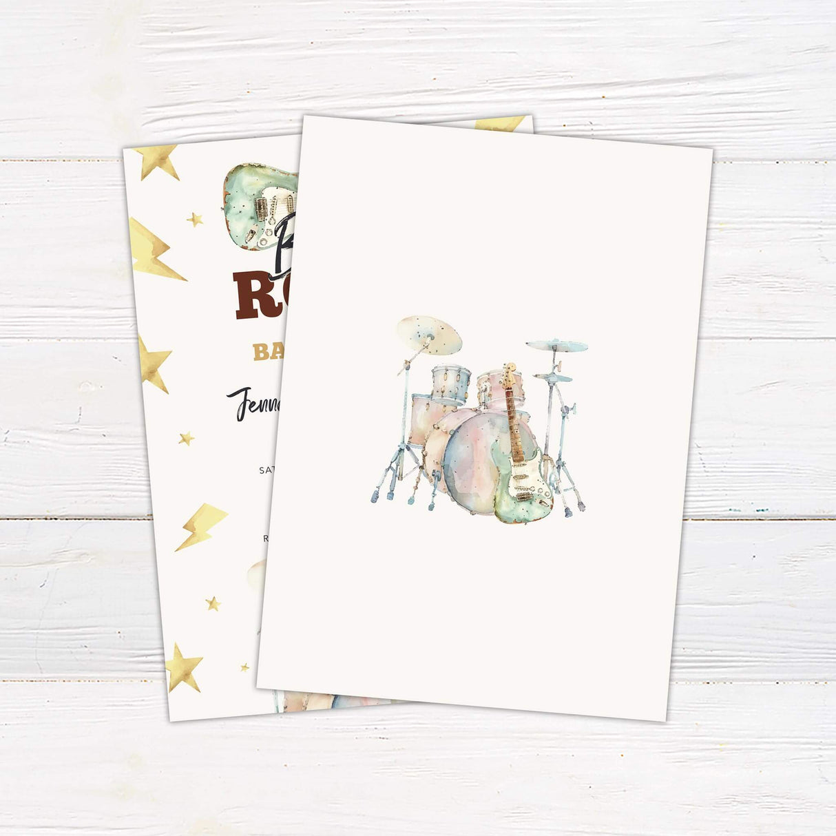 Born to Rock baby shower invitation featuring a watercolor drum kit, electric guitar, lightning bolts, and stars.
