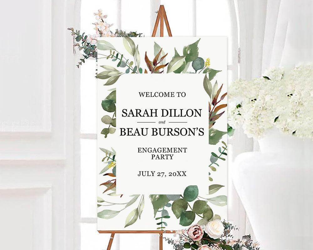 Botanical-themed engagement party sign with greenery and flowers.