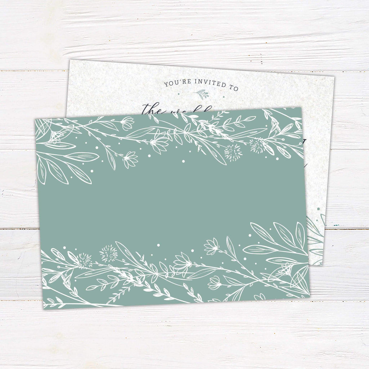 Elegant wedding invitation with green botanical accents and script and serif typography, ideal for garden, outdoor, or nature-themed weddings - back
