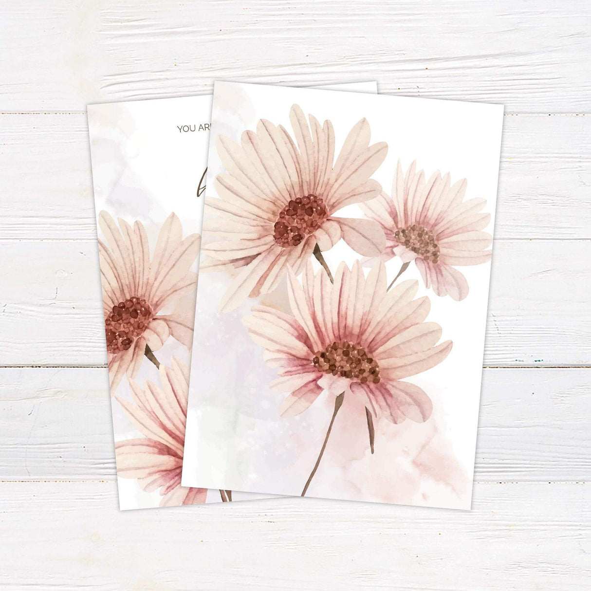 Soft pink daisy floral in the bottom left corner with mixed font wording on the right side.Watercolor floral wedding invitation with hand-painted daisy-inspired blooms and elegant script, perfect for spring and garden weddings.