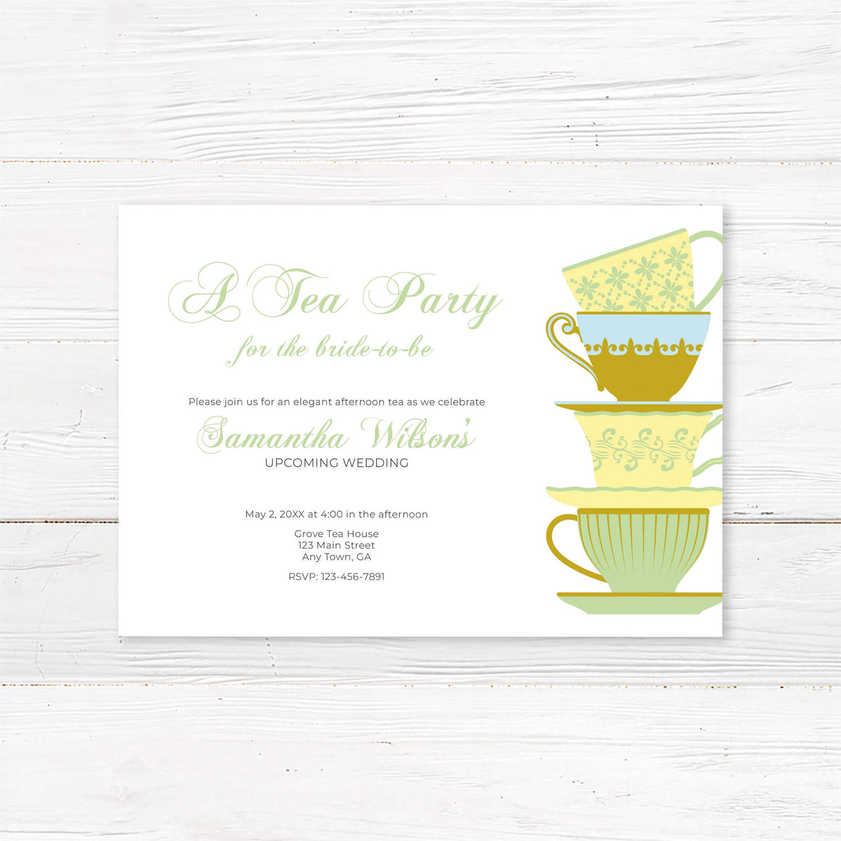 Elegant bridal tea party invitation featuring a stack of vintage teacups in soft green and gold hues. Customizable with the bride’s name, event details, and RSVP information.