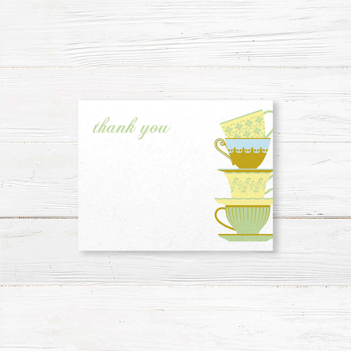 Matching bridal tea thank you card featuring a delicate stack of teacups design. Elegant script with space for a handwritten note or pre-printed message.