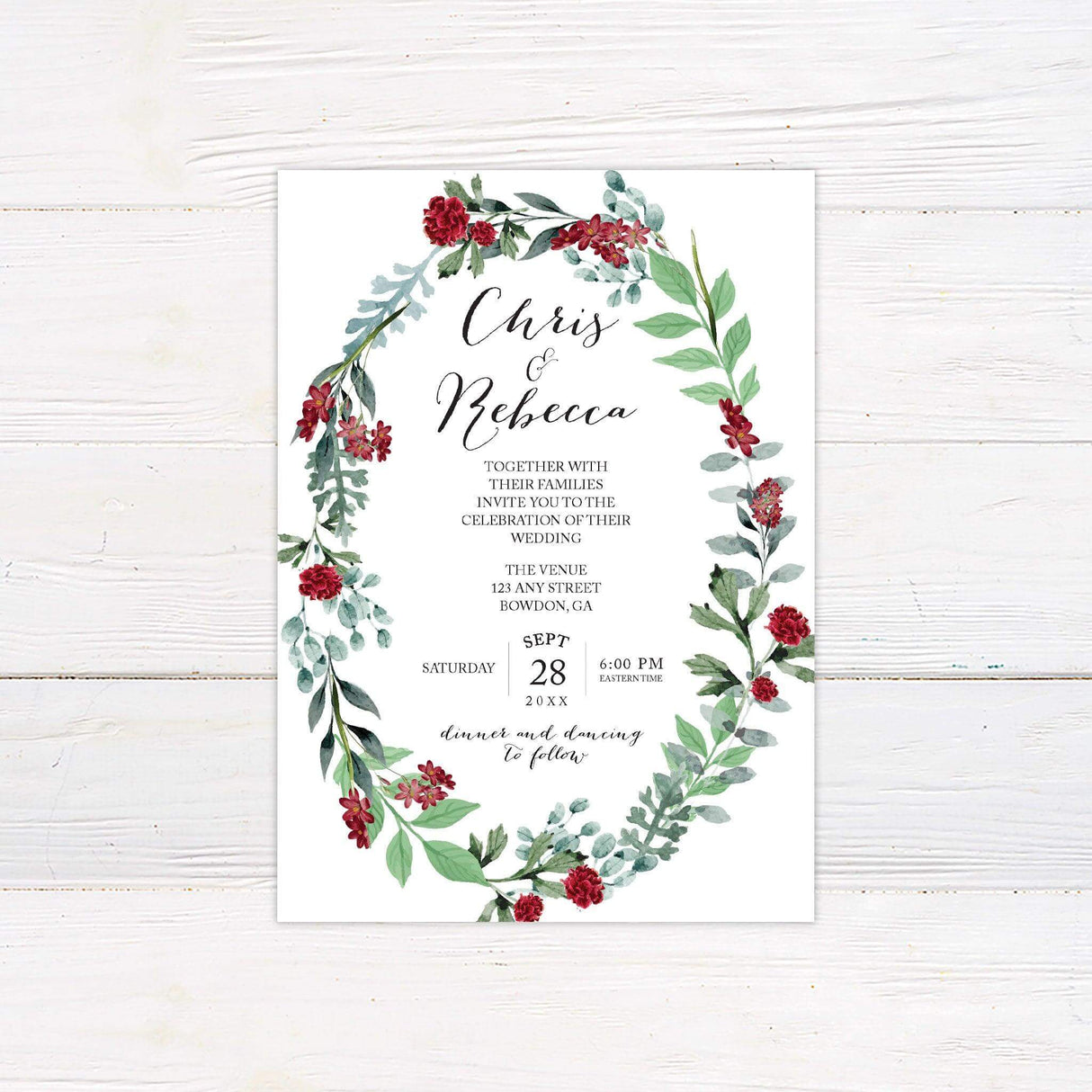Wedding invitation with a floral wreath of burgundy blooms and greenery, featuring elegant calligraphy and customizable ceremony details.