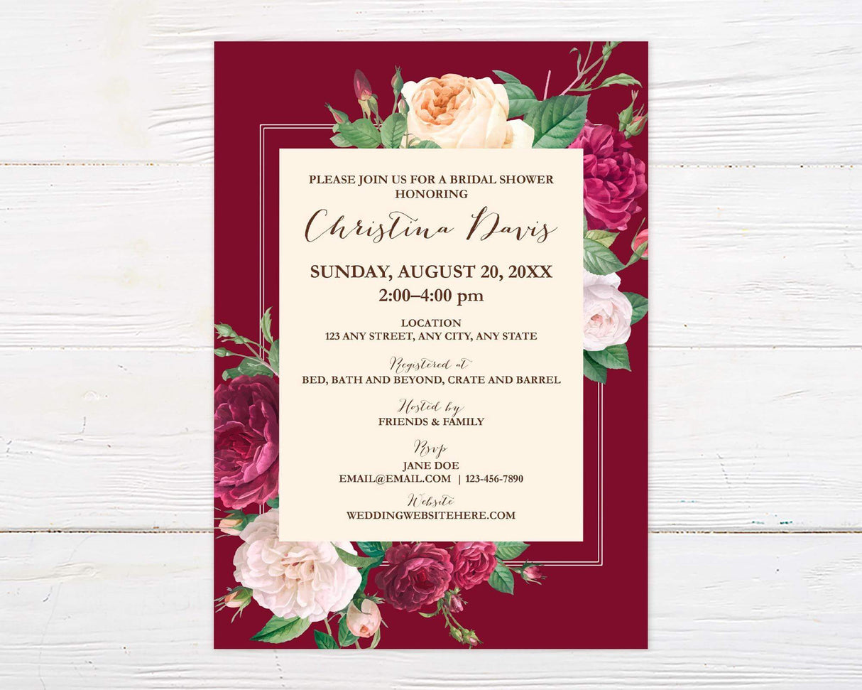 A burgundy rose floral bridal shower invitation with roses and elegant script text. The design features deep red and blush flowers on a dark background.