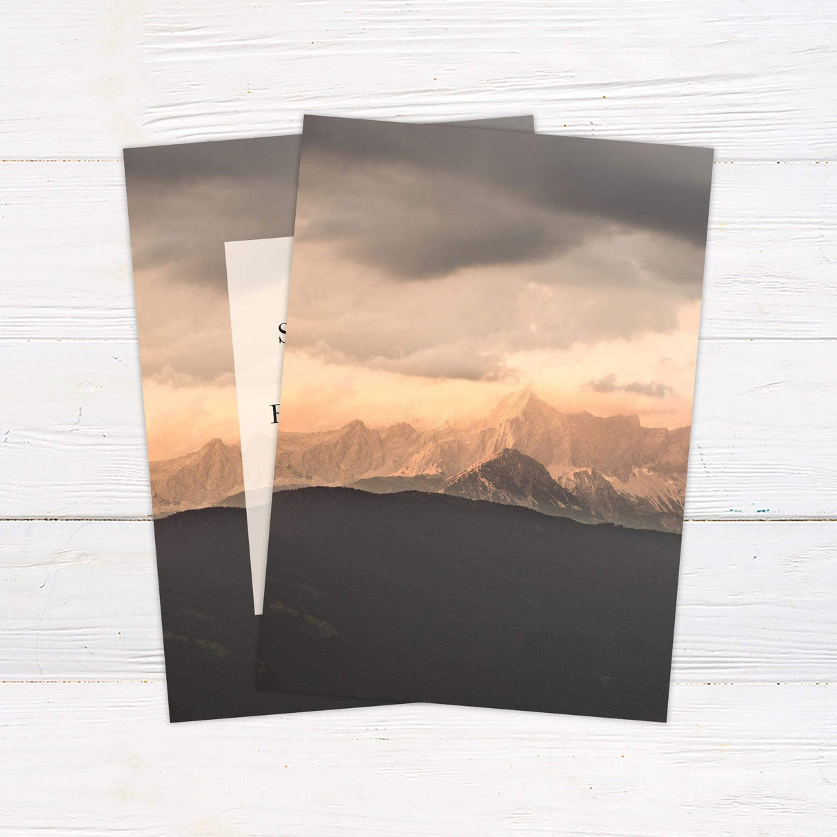 Elegant wedding invitation with a mountain canyon background, featuring classic serif and script fonts on a translucent overlay. - back