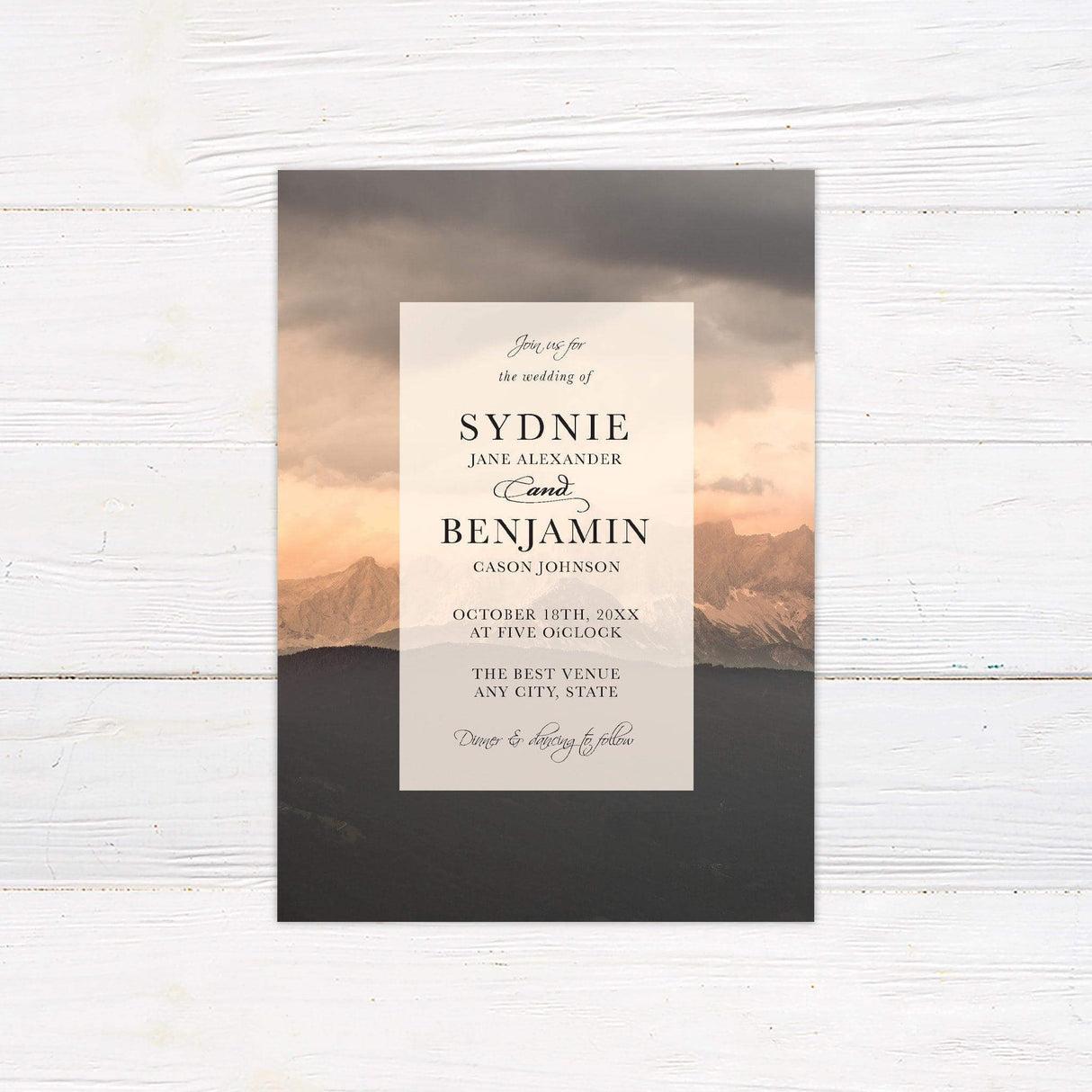 Elegant wedding invitation with a mountain canyon background, featuring classic serif and script fonts on a translucent overlay.