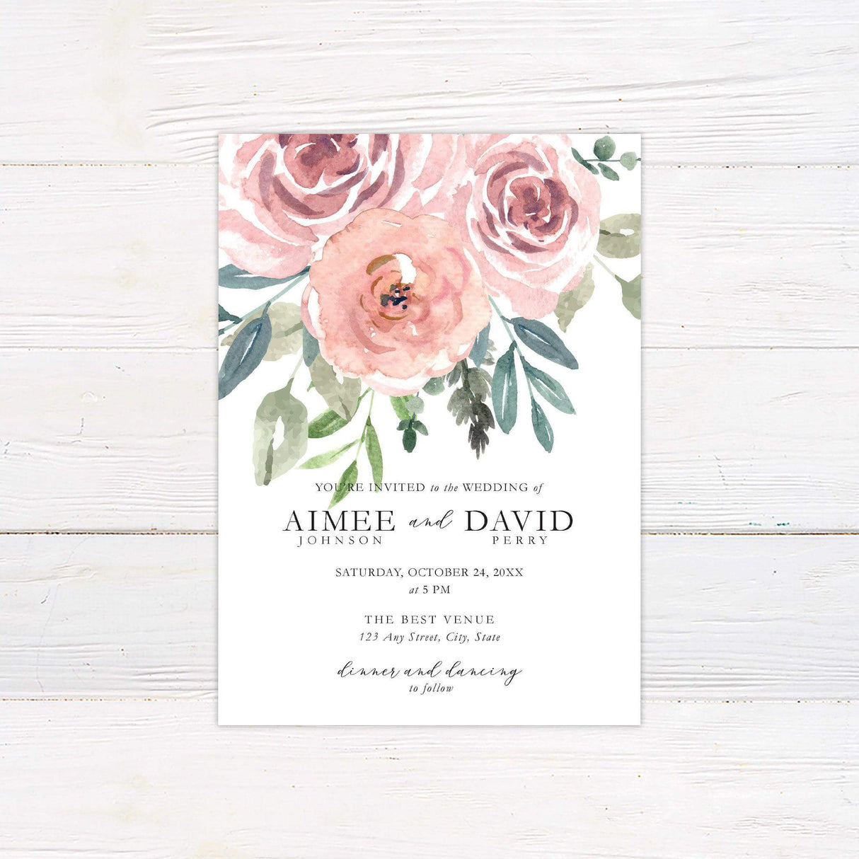 Wedding invitation with watercolor blush roses cascading from the top, featuring elegant serif and script fonts on a white background.