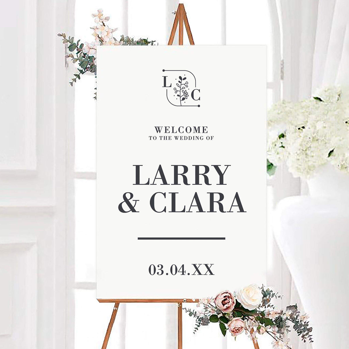 Casual monogram wedding welcome sign featuring a botanical monogram, large couple names, and wedding date in charcoal gray. The clean black and white design uses elegant serif typography on a simple white background.