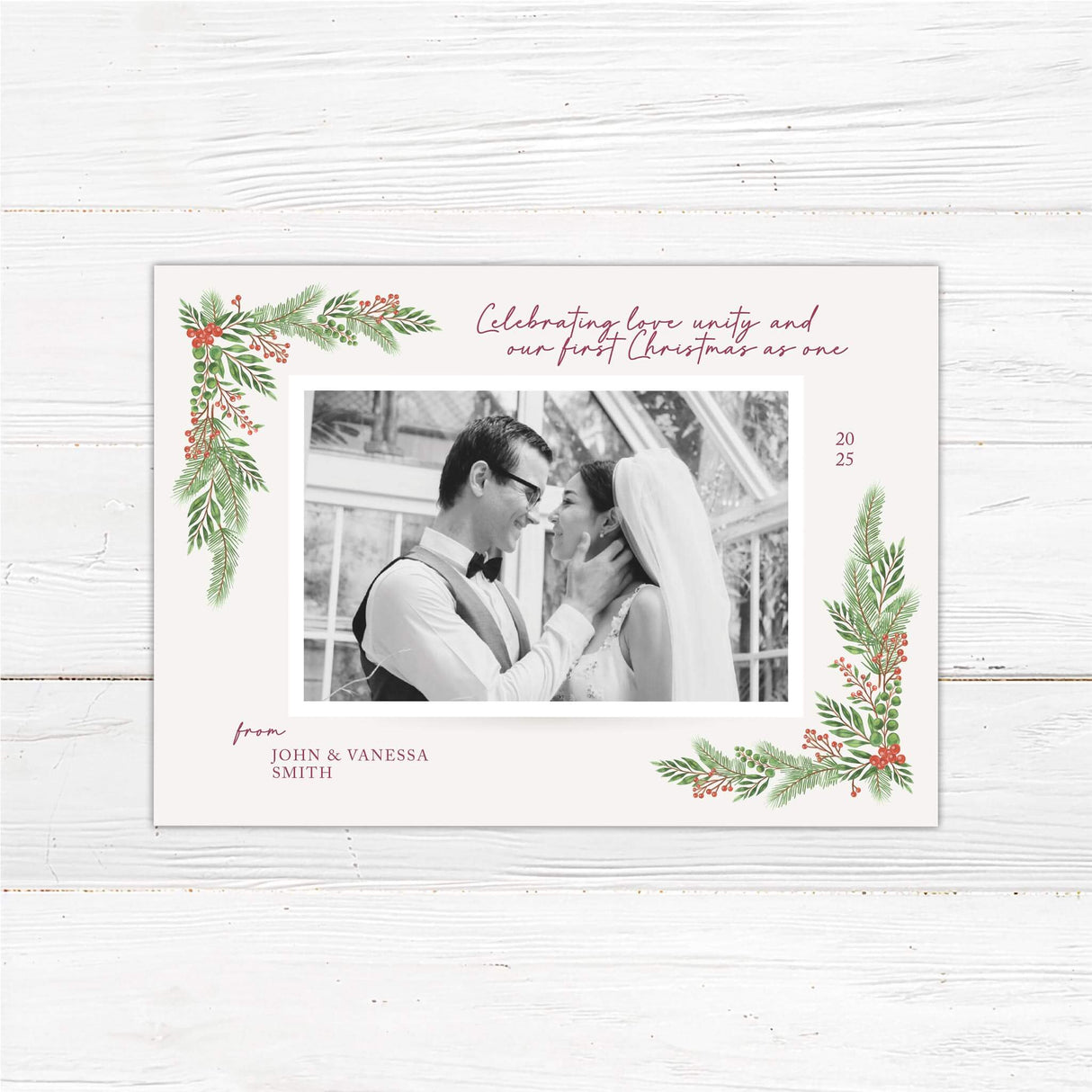 Elegant wedding-themed Christmas card with photo of newlywed couple, holiday greenery, and personalized message.