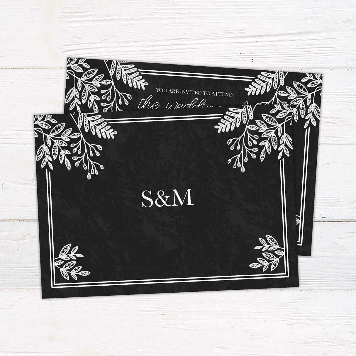 Rustic chalkboard wedding invitation with white botanical leaf illustrations and elegant handwritten script and serif fonts. - back