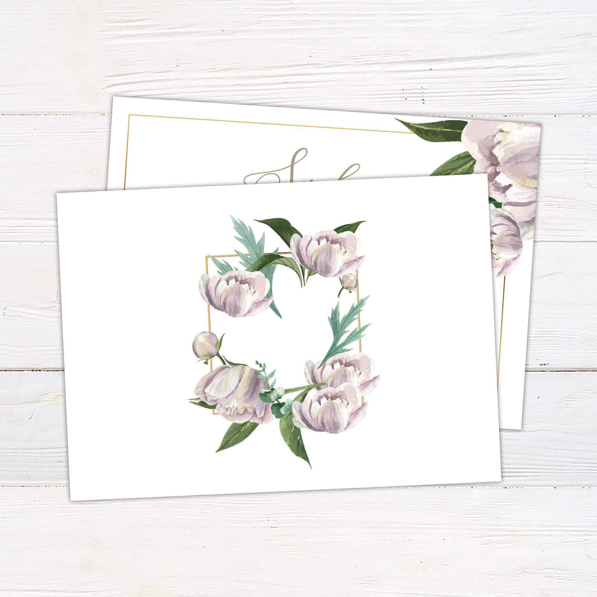 Wedding invitation with soft lavender watercolor flowers, green foliage, elegant script fonts, and a gold border on a white background. - back