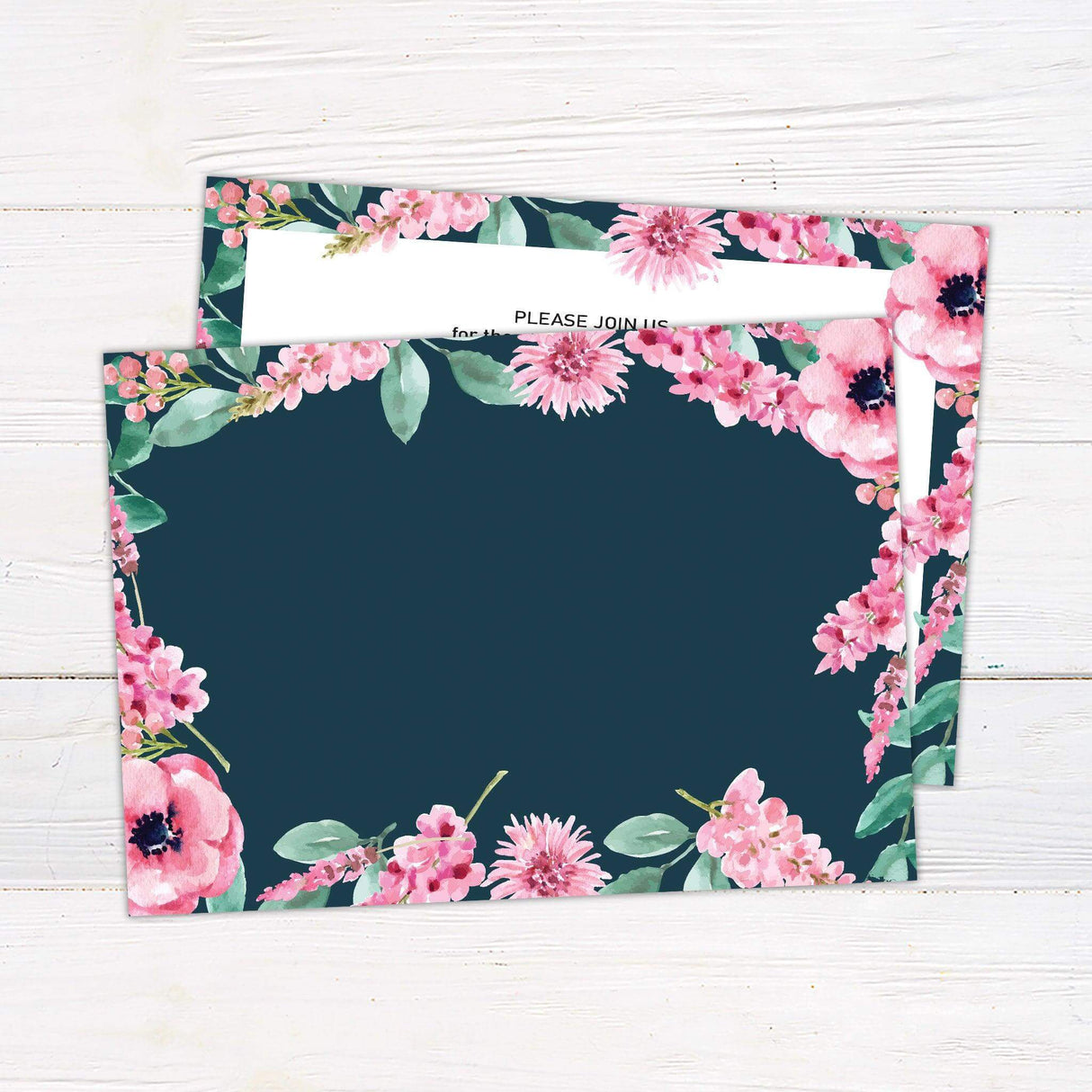 Wedding invitation with bright watercolor pink and purple floral border on navy background and modern script text on a white center panel. 0 back